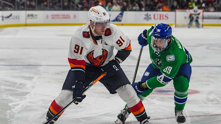 Coachella Valley forward Daniel Sprong looks to shoot while defended against by Abbotsford forward Ty Mueller during the second period of their game at Acrisure Arena in Palm Desert, Calif., Wednesday, Jan. 29, 2025.