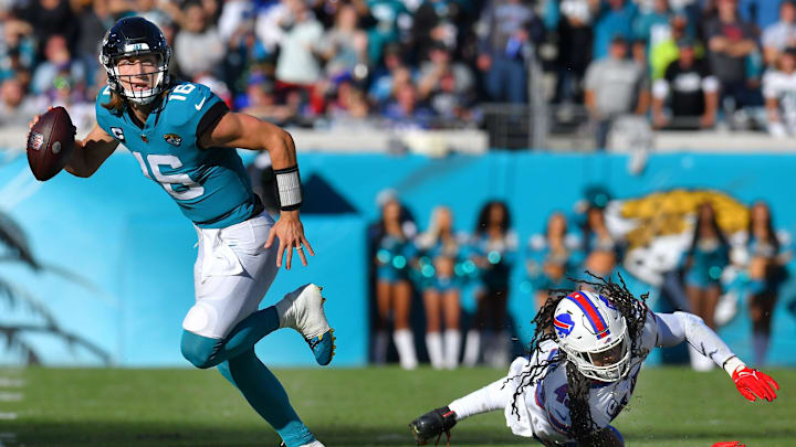 Jacksonville Jaguars quarterback Trevor Lawrence (16) scrambles away from Buffalo Bills linebacker