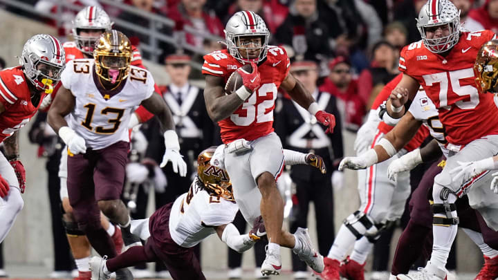 Nov 18, 2023; Columbus, Ohio, USA; Ohio State Buckeyes running back TreVeyon Henderson (32) runs over Minnesota Golden Gophers defensive back Tre'Von Jones (2) during the first half of the NCAA football game at Ohio Stadium. Nov 18, 2023; Columbus, Ohio, USA; Ohio State Buckeyes running back TreVeyon Henderson (32) runs over Minnesota Golden Gophers defensive back Tre'Von Jones (2) during the first half of the NCAA football game at Ohio Stadium.