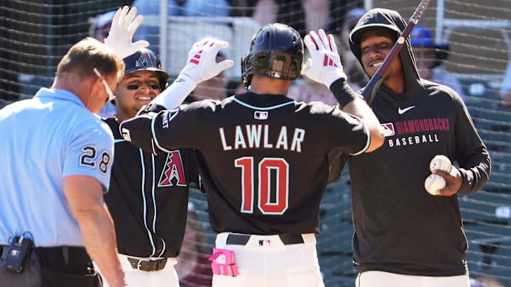 Arizona Diamondbacks Jordan Lawlar celebrates with Gabriel Moreno and Geraldo Perdomo after hitting a two-run home run off Milwaukee Brewers pitcher Tyler Alexander in the second inning of a spring training game on Feb. 26, 2025, in Scottsdale at Salt River Fields at Talking Stick.