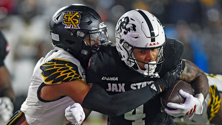 Jax State's Cam Cook tries to evade the tackle of Kennesaw State's Alexander Ford during the C-USA Championship at AmFirst Stadium in Jacksonville, Alabama December 5, 2025. (Dave Hyatt / Hyatt Media LLC) Jax State's Cam Cook tries to evade the tackle of Kennesaw State's Alexander Ford during the C-USA Championship at AmFirst Stadium in Jacksonville, Alabama December 5, 2025. (Dave Hyatt / Hyatt Media LLC)