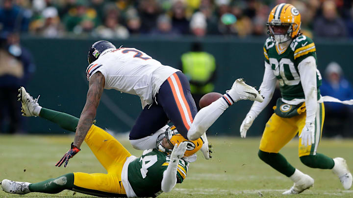 Green Bay Packers cornerback Carrington Valentine knocks the ball loose following a reception by Chicago Bears wide receiver DJ Moore/