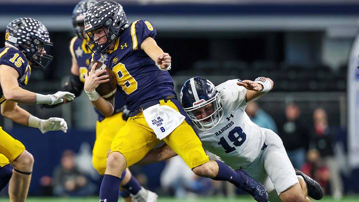Quarterback Buck Randall of Highland Park carries while attempting to elude a Smithson Valley defender during Texas 5A Division 1 title game. Quarterback Buck Randall of Highland Park carries while attempting to elude a Smithson Valley defender during Texas 5A Division 1 title game.