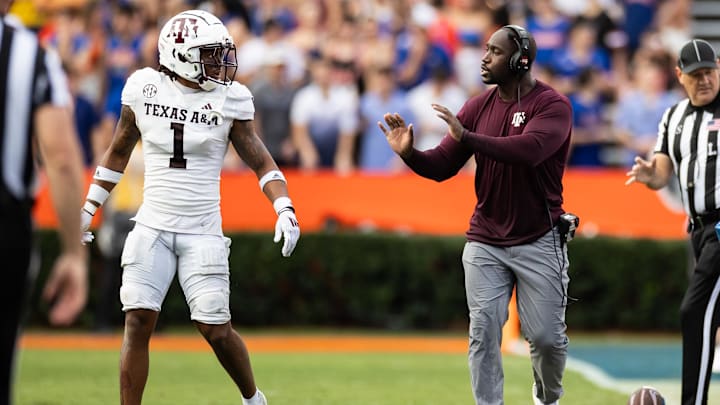 Texas A&M Aggies defensive backs coach Ishmael Aristide gestures towards Texas A&M Aggies defensive back Bryce Anderson (1) against the Florida Gators during the first half at Ben Hill Griffin Stadium.