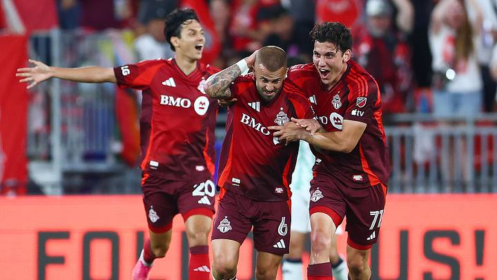 Daniel Salloi and Markus Cimermancic celebrate with Niklas Dorsch after Dorsch's game-winning goal.
