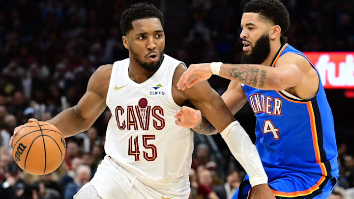 Jan 8, 2025; Cleveland, Ohio, USA; Cleveland Cavaliers guard Donovan Mitchell (45) drives to the basket against Oklahoma City Thunder forward Kenrich Williams (34) during the second half at Rocket Mortgage FieldHouse. Mandatory Credit: Ken Blaze-Imagn Images