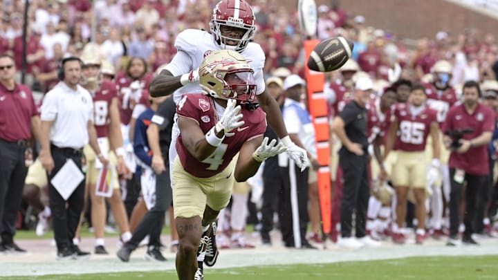 Aug 30, 2025; Tallahassee, Florida, USA; Florida State Seminoles wide receiver Squirrel White (4) makes a catch against Alabama Crimson Tide defensive back Dijon Lee Jr. (5) during the first half at Doak S. Campbell Stadium. Mandatory Credit: Melina Myers-Imagn Images