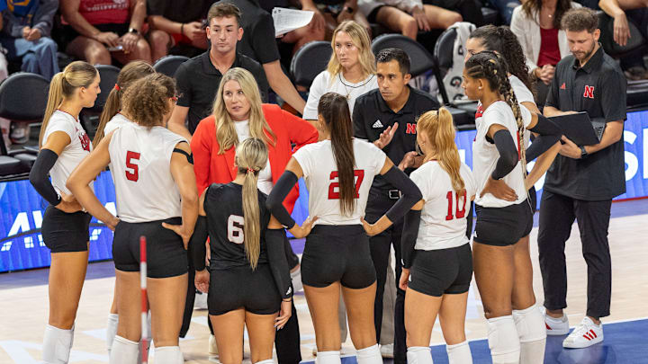 Nebraska Volleyball Head Coach Dani Busboom Kelly and members of the coaching staff huddle on the sideline during the AVCA First Serve vs. Pittsburgh. The Huskers will play a nonconference match against rival Texas in 2026. 