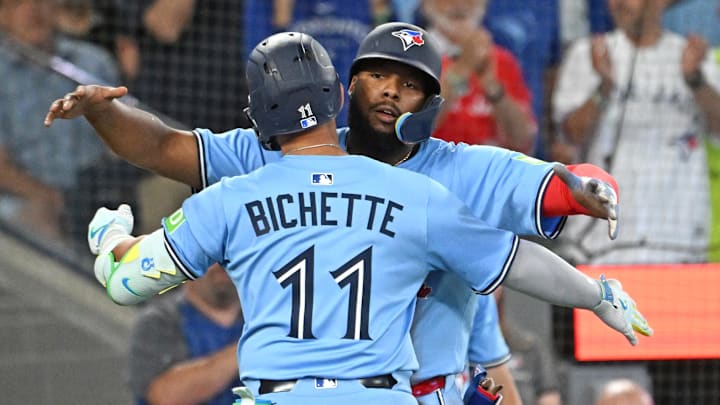 Jul 23, 2025; Toronto, Ontario, CAN;  Toronto Blue Jays shortstop Bo Bichette (11) is greeted by first baseman Vladimir Guerrero Jr. (27) after hitting a two run home run against the New York Yankees in the seventh inning at Rogers Centre. 