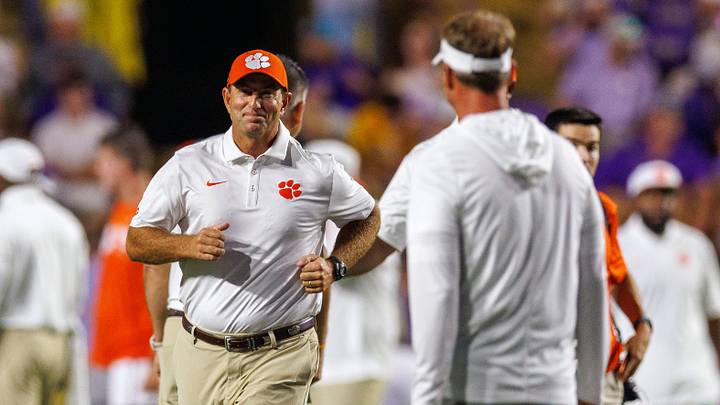 Sep 5, 2026; Baton Rouge, Louisiana, USA;  Clemson Tigers head coach Dabo Swinney runs to greet LSU Tigers head coach Lane Kiffin before a game at Tiger Stadium.  Mandatory Credit: Stephen Lew-Imagn Images