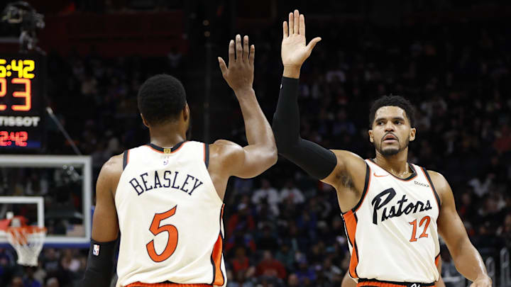 Nov 25, 2024; Detroit, Michigan, USA;  Detroit Pistons guard Malik Beasley (5) and forward Tobias Harris (12) celebrates in the first half against the Toronto Raptors at Little Caesars Arena. Mandatory Credit: Rick Osentoski-Imagn Images