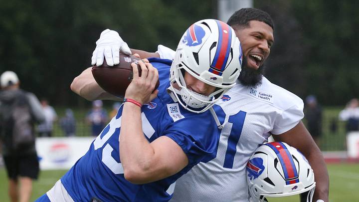 Bills defensive line Ed Oliver jokingly tries to strip the ball from tight end Jackson Hawes as they warm up before day two of Buffalo Bills training camp at St. John Fisher University Thursday, July 30, 2026 in Pittsford. Bills defensive line Ed Oliver jokingly tries to strip the ball from tight end Jackson Hawes as they warm up before day two of Buffalo Bills training camp at St. John Fisher University Thursday, July 30, 2026 in Pittsford.