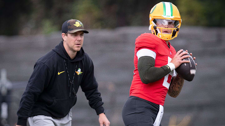 Oregon quarterback Dillon Gabriel throws out a pass as offensive coordinator Will Stein during practice with the Oregon Ducks Tuesday, Aug. 27, 2024 at the Hatfield-Dowlin Complex in Eugene, Ore.