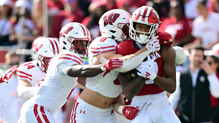 Nov 15, 2025; Bloomington, Indiana, USA; Indiana Hoosiers wide receiver E.J. Williams Jr. (7) is tackled by Wisconsin Badgers linebacker Christian Alliegro (0) during the second quarter at Memorial Stadium. Nov 15, 2025; Bloomington, Indiana, USA; Indiana Hoosiers wide receiver E.J. Williams Jr. (7) is tackled by Wisconsin Badgers linebacker Christian Alliegro (0) during the second quarter at Memorial Stadium.