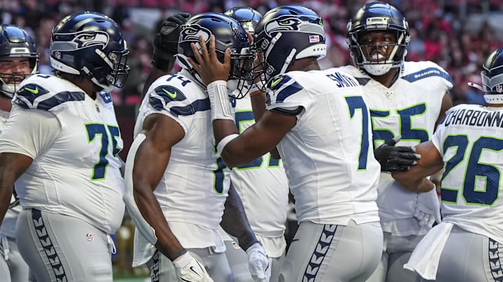 Oct 20, 2024; Atlanta, Georgia, USA; Seattle Seahawks wide receiver DK Metcalf (14) reacts with quarterback Geno Smith (7) after catching a touchdown pass against the Atlanta Falcons during the first half at Mercedes-Benz Stadium. Mandatory Credit: Dale Zanine-Imagn Images