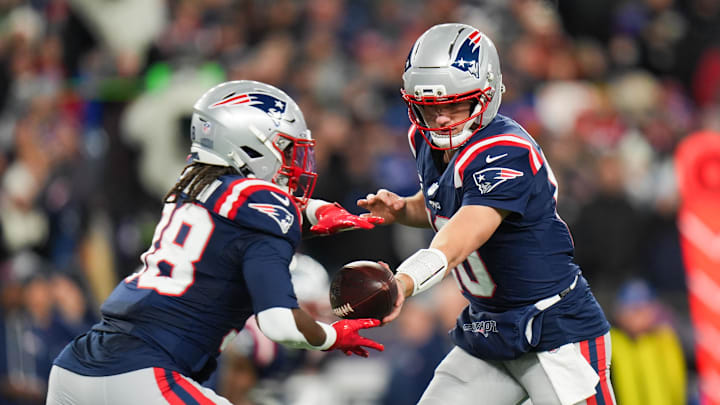 Jan 11, 2026; Foxborough, MA, USA; New England Patriots quarterback Drake Maye (10) hands the ball off to New England Patriots running back Rhamondre Stevenson (38) during the first quarter against the Los Angeles Chargers in an AFC Wild Card Round game at Gillette Stadium. Mandatory Credit: David Butler II-Imagn Images