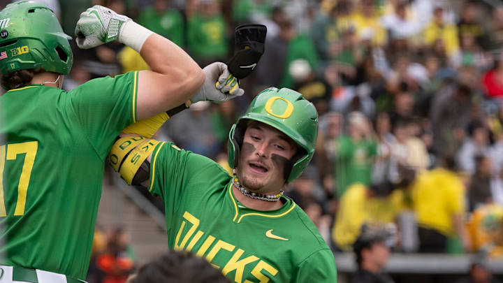 Oregon outfielder Mason Neville, right, celebrates a home run with teammate Drew Smith as the Oregon Ducks host the Oregon State Beavers on April 25, 2025, at PK Park in Eugene.