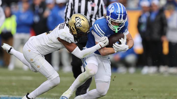 Nov 29, 2025; Provo, Utah, USA; UCF Knights defensive back Braeden Marshall (4) tackled BYU Cougars wide receiver Parker Kingston (11) during the second half at LaVell Edwards Stadium. Mandatory Credit: Rob Gray-Imagn Images