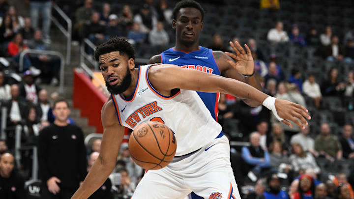 Nov 1, 2024; Detroit, Michigan, USA; New York Knicks center Karl-Anthony Towns (32) battles for a loose ball with Detroit Pistons center Jalen Duren (0) in the first quarter at Little Caesars Arena. Mandatory Credit: Lon Horwedel-Imagn Images