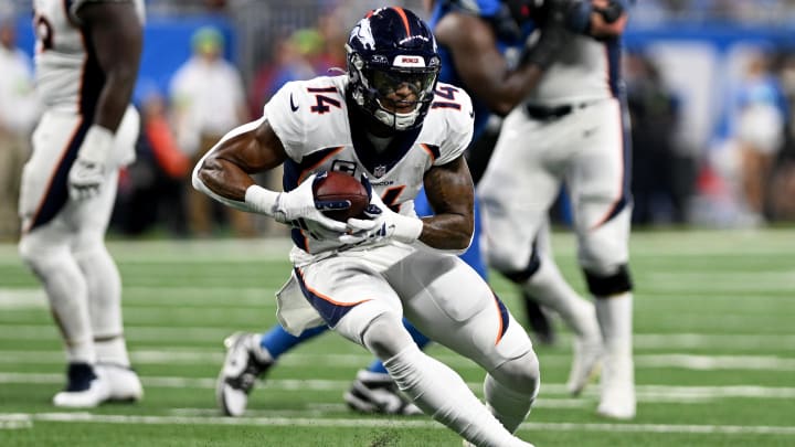 Dec 16, 2023; Detroit, Michigan, USA; Denver Broncos wide receiver Courtland Sutton (14) runs with the ball against the Detroit Lions in the third quarter at Ford Field. 