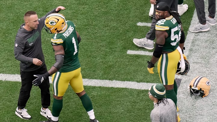Green Bay Packers defensive coordinator Jeff Hafley hugs defensive end Micah Parsons before the game against Detroit.