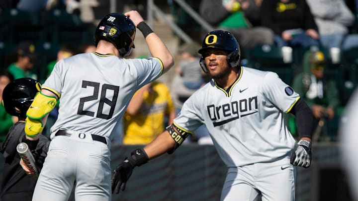 Oregon first baseman Jacob Walsh and Oregon outfielder Bryce Boettcher celebrate a home run by Walsh,