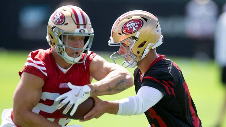 San Francisco 49ers quarterback Brock Purdy (13) hands off to running back Christian McCaffrey (23)