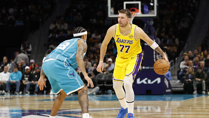 Nov 10, 2025; Charlotte, North Carolina, USA; Los Angeles Lakers forward/guard Luka Doncic (77) is guarded by Charlotte Hornets guard Tre Mann (23) during the second quarter at Spectrum Center. Mandatory Credit: Brian Westerholt-Imagn Images Nov 10, 2025; Charlotte, North Carolina, USA; Los Angeles Lakers forward/guard Luka Doncic (77) is guarded by Charlotte Hornets guard Tre Mann (23) during the second quarter at Spectrum Center. Mandatory Credit: Brian Westerholt-Imagn Images