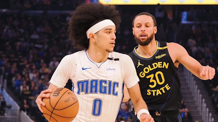 Orlando Magic guard Anthony Black (0) controls the ball against Golden State Warriors guard Stephen Curry (30) during the first quarter at Chase Center.