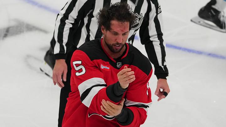Oct 6, 2026; Newark, New Jersey, USA;  New Jersey Devils defenseman Brenden Dillon (5) goes to the penalty box for fighting against the Utah Mammoth during the third period at Prudential Center.  Mandatory Credit: Ed Mulholland-Imagn Images
