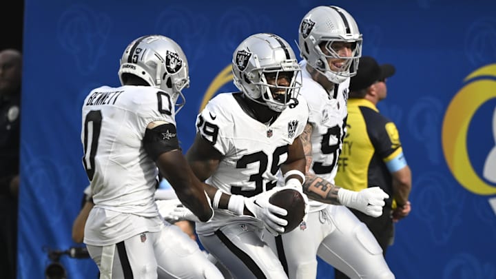 Oct 20, 2024; Inglewood, California, USA; Las Vegas Raiders cornerback Nate Hobbs (39) celebrates intercepting a Los Angeles Rams quarterback Matthew Stafford (not pictured) pass during the third quarter at SoFi Stadium. Left is Las Vegas Raiders cornerback Jakorian Bennett (0), right is defensive end Maxx Crosby (98). Mandatory Credit: Robert Hanashiro-Imagn Images