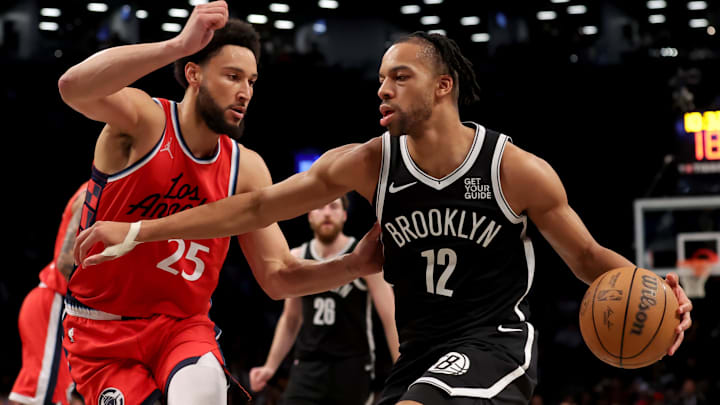 Mar 28, 2025; Brooklyn, New York, USA; Brooklyn Nets forward Tosan Evbuomwan (12) drives to the basket against Los Angeles Clippers guard Ben Simmons (25) during the fourth quarter at Barclays Center. Mandatory Credit: Brad Penner-Imagn Images Mar 28, 2025; Brooklyn, New York, USA; Brooklyn Nets forward Tosan Evbuomwan (12) drives to the basket against Los Angeles Clippers guard Ben Simmons (25) during the fourth quarter at Barclays Center. Mandatory Credit: Brad Penner-Imagn Images