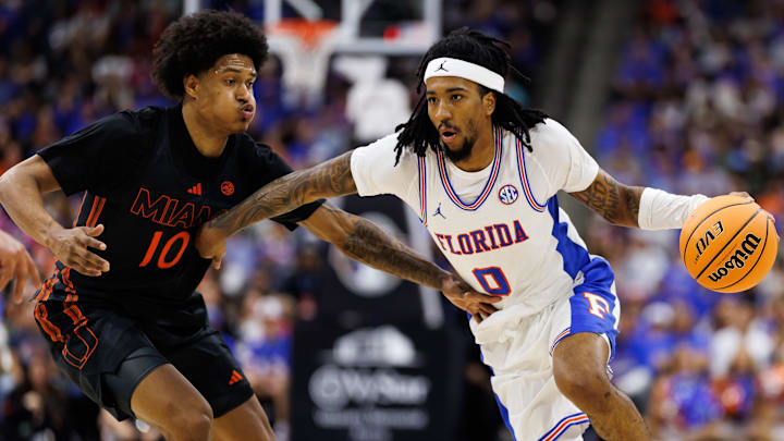 Nov 16, 2025; Jacksonville, Florida, USA; Florida Gators guard Boogie Fland (0) drives to the basket while Miami Hurricanes guard Tru Washington (10) defends during the first half at VyStar Veterans Memorial Arena. Mandatory Credit: Matt Pendleton-Imagn Images