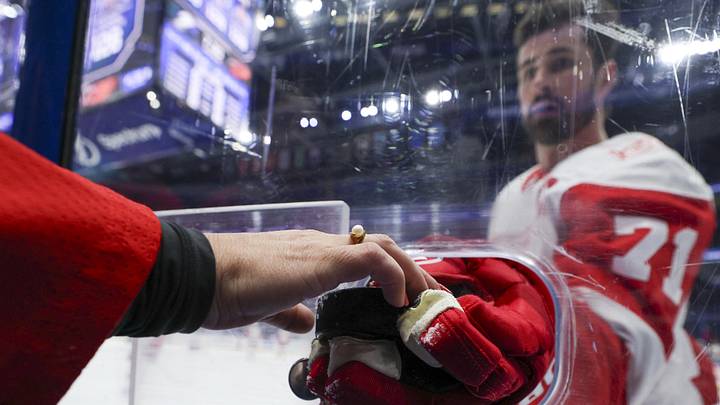 Apr 13, 2026; Tampa, Florida, USA; Detroit Red Wings center Dylan Larkin (71) gives a puck to a fan before a game against the Tampa Bay Lightning at Benchmark International Arena. Mandatory Credit: Nathan Ray Seebeck-Imagn Images