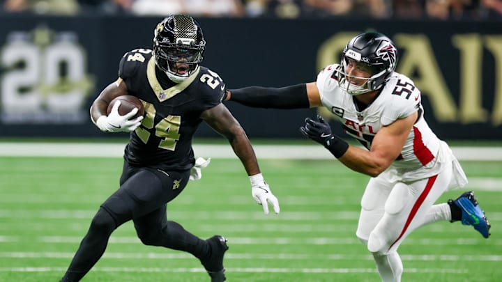 Nov 23, 2025; New Orleans, Louisiana, USA; New Orleans Saints running back Devin Neal (24) carries the ball as Atlanta Falcons linebacker Kaden Elliss (55) defends during the second half at Caesars Superdome. Mandatory Credit: Stephen Lew-Imagn Images