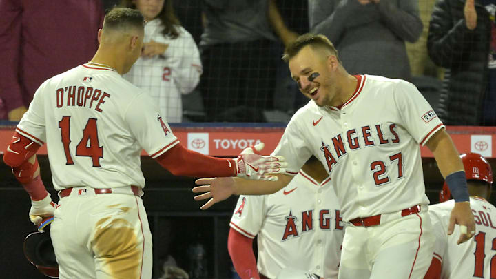 Apr 5, 2025; Anaheim, California, USA;  Los Angeles Angels catcher Logan O'Hoppe (14) is congratulated at the dugout by center fielder Mike Trout (27) after hitting a two-run home run in the fifth inning against the Cleveland Guardians at Angel Stadium. Mandatory Credit: Jayne Kamin-Oncea-Imagn Images