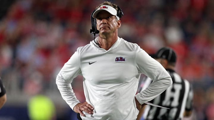 Nov 15, 2025; Oxford, Mississippi, USA; Mississippi Rebels head coach Lane Kiffin looks on during a time out during the first quarter against the Florida Gators at Vaught-Hemingway Stadium. Mandatory Credit: Petre Thomas-Imagn Images Nov 15, 2025; Oxford, Mississippi, USA; Mississippi Rebels head coach Lane Kiffin looks on during a time out during the first quarter against the Florida Gators at Vaught-Hemingway Stadium. Mandatory Credit: Petre Thomas-Imagn Images