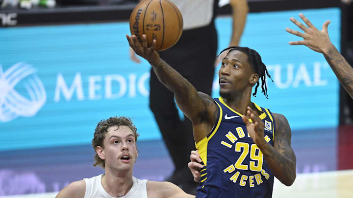 Oct 10, 2024; Cleveland, Ohio, USA; Indiana Pacers guard Quenton Jackson (29) drives to the basket beside Cleveland Cavaliers guard Luke Travers (33) in the fourth quarter at Rocket Mortgage FieldHouse. Mandatory Credit: David Richard-Imagn Images