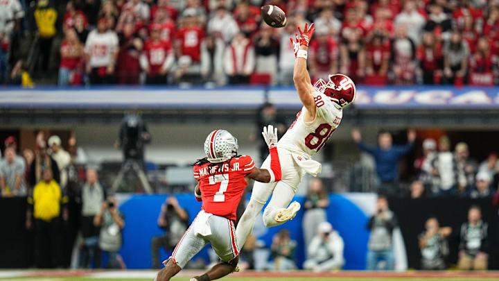 Indiana Hoosiers wide receiver Charlie Becker (80) makes a first down catch over Ohio State Buckeyes cornerback Jermaine Mathews Jr. (7) during the Big Ten Conference championship game at Lucas Oil Stadium in Indianapolis on Dec. 6, 2025. Ohio State lost 13-10.