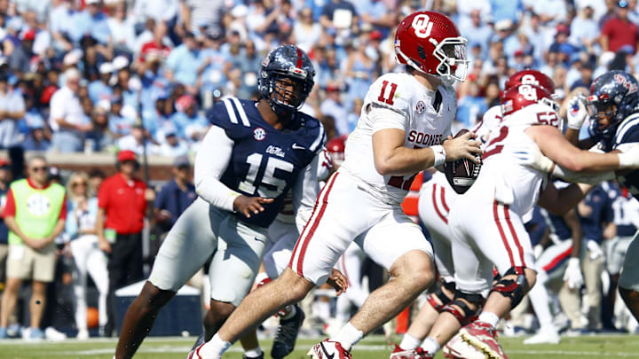 Oct 26, 2024; Oxford, Mississippi, USA; Oklahoma Sooners quarterback Jackson Arnold (11) scrambles as Mississippi Rebels defensive  Jared Ivey (15) pursues during the first half at Vaught-Hemingway Stadium. Mandatory Credit: Petre Thomas-Imagn Images