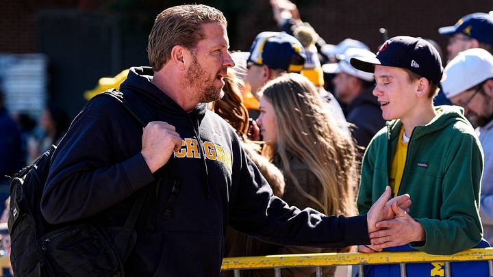 Michigan offensive coordinator Jason Beck shakes hands with fans as the team arrive ahead of the game between Michigan and Penn State Michigan offensive coordinator Jason Beck shakes hands with fans as the team arrive ahead of the game between Michigan and Penn State