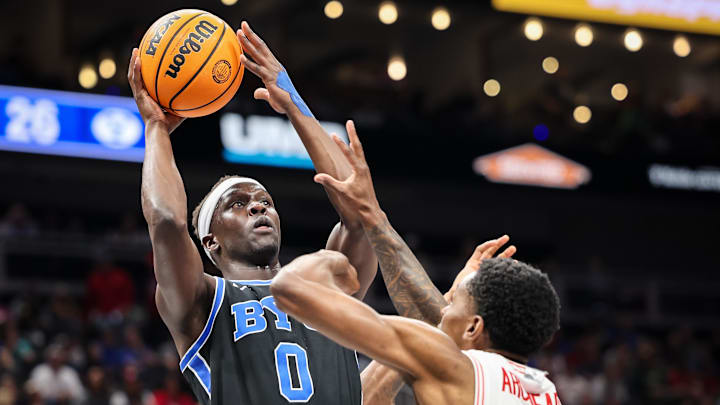 Mar 14, 2025; Kansas City, MO, USA; Brigham Young Cougars forward Mawot Mag (0) shoots the ball during the second half against the Houston Cougars at T-Mobile Center. Mandatory Credit: William Purnell-Imagn Images Mar 14, 2025; Kansas City, MO, USA; Brigham Young Cougars forward Mawot Mag (0) shoots the ball during the second half against the Houston Cougars at T-Mobile Center. Mandatory Credit: William Purnell-Imagn Images