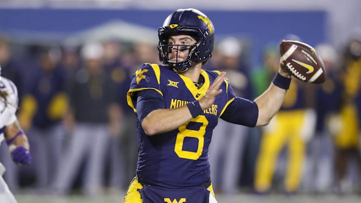 Oct 19, 2024; Morgantown, West Virginia, USA; West Virginia Mountaineers quarterback Nicco Marchiol (8) throws for a touchdown during the fourth quarter against the Kansas State Wildcats at Mountaineer Field at Milan Puskar Stadium. Mandatory Credit: Ben Queen-Imagn Images Oct 19, 2024; Morgantown, West Virginia, USA; West Virginia Mountaineers quarterback Nicco Marchiol (8) throws for a touchdown during the fourth quarter against the Kansas State Wildcats at Mountaineer Field at Milan Puskar Stadium. Mandatory Credit: Ben Queen-Imagn Images
