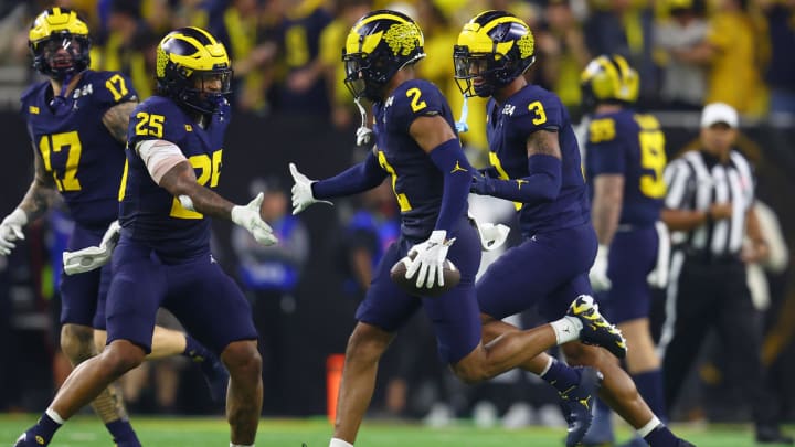 Jan 8, 2024; Houston, TX, USA; Michigan Wolverines defensive back Will Johnson (2) celebrates with linebacker Junior Colson (25) after a turnover against the Washington Huskies during the third quarter in the 2024 College Football Playoff national championship game at NRG Stadium. Mandatory Credit: Mark J. Rebilas-USA TODAY Sports Jan 8, 2024; Houston, TX, USA; Michigan Wolverines defensive back Will Johnson (2) celebrates with linebacker Junior Colson (25) after a turnover against the Washington Huskies during the third quarter in the 2024 College Football Playoff national championship game at NRG Stadium. Mandatory Credit: Mark J. Rebilas-USA TODAY Sports