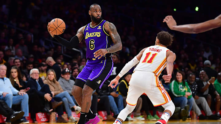 Jan 6, 2023; Los Angeles, California, USA; Los Angeles Lakers forward LeBron James (6) controls the ball against Atlanta Hawks guard Trae Young (11) during the second half at Crypto.com Arena. Mandatory Credit: Gary A. Vasquez-Imagn Images