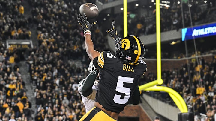 Nov 22, 2025; Iowa City, Iowa, USA; Iowa Hawkeyes wide receiver Jacob Gill (5) catches the game-tying touchdown as Michigan State Spartans defensive back Dontavius Nash (28) defends during the fourth quarter at Kinnick Stadium. Mandatory Credit: Jeffrey Becker-Imagn Images