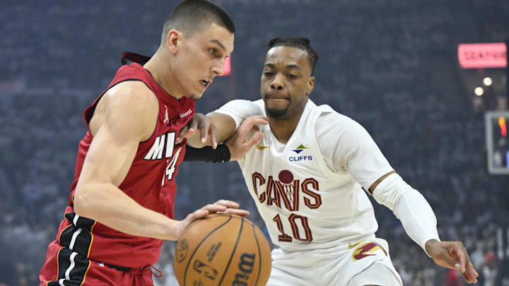 Apr 20, 2025; Cleveland, Ohio, USA; Miami Heat guard Tyler Herro (14) drives against Cleveland Cavaliers guard Darius Garland (10) in the first quarter at Rocket Arena. Mandatory Credit: David Richard-Imagn Images