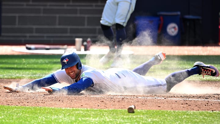 Sep 15, 2024; Toronto, Ontario, CAN;  Toronto Blue Jays pinch hitter George Springer (4) scores the winning run against the St. Louis Cardinals in the eighth inning at Rogers Centre. Mandatory Credit: Dan Hamilton-Imagn Images