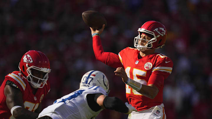 Nov 23, 2025; Kansas City, Missouri, USA; Kansas City Chiefs quarterback Patrick Mahomes (15) throws a pass against Indianapolis Colts defensive end Laiatu Latu (97) in the first half at GEHA Field at Arrowhead Stadium. Mandatory Credit: Jay Biggerstaff-Imagn Images