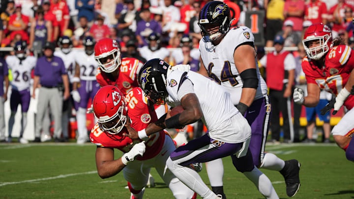 Sep 28, 2025; Kansas City, Missouri, USA; Baltimore Ravens quarterback Lamar Jackson (8) is sacked by Kansas City Chiefs defensive tackle Jerry Tillery (99) during the first quarter at GEHA Field at Arrowhead Stadium. Mandatory Credit: Denny Medley-Imagn Images